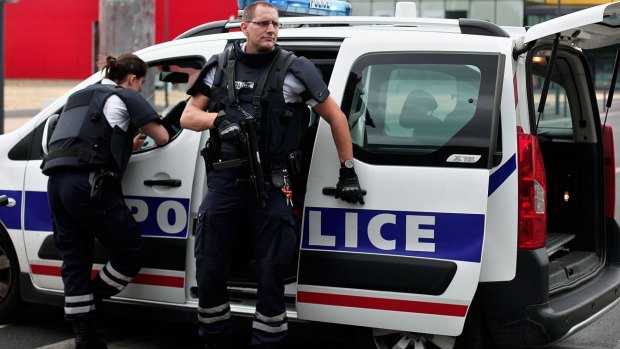 Police officers respond to the hostage situation north of Paris in an unrelated incident in July.