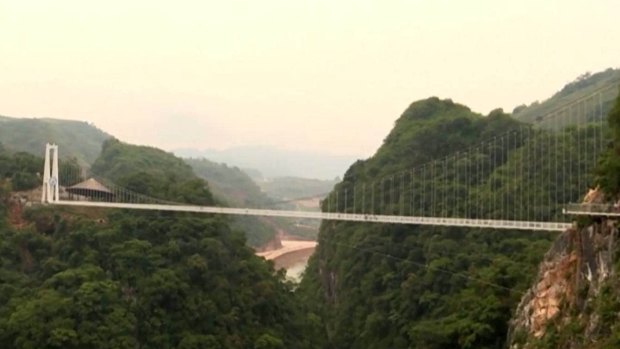 The bridge spans two peaks in Vietnam.
