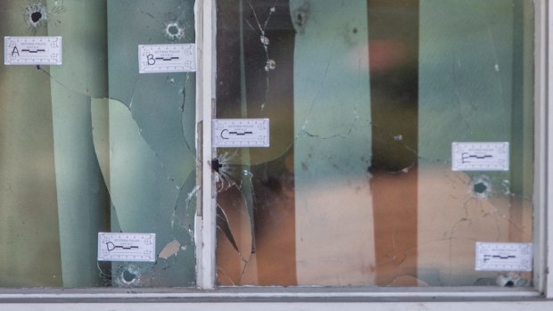 The six bullet holes in the window of a Darebin Drive property in Thomastown, where a man was shot and killed last week.