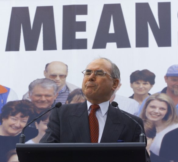 John Howard stands next to a 'cheaper diesel means cheaper goods' sign.