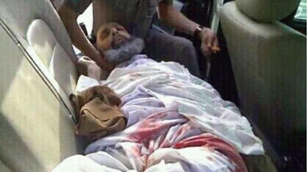 Sheikh Nimr lies wounded in the back of a Saudi police car on July 8, 2012, the day of his arrest.