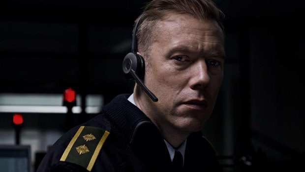 Police dispatcher Asger Holm (Jakob Cedergren) handles calls during a night shift in <i>The Guilty</i>.