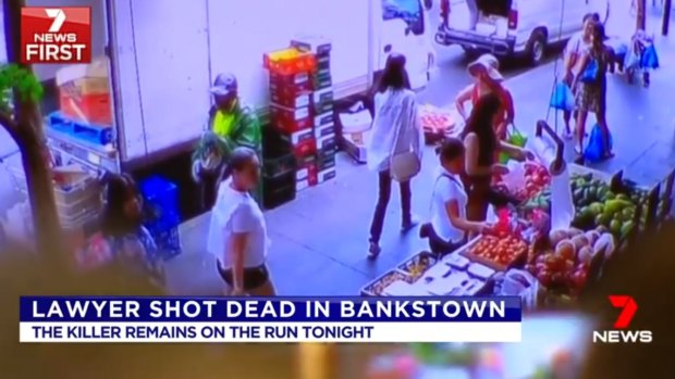 CCTV footage from a nearby shop shows a man, dressed in a hi-visibility vest and a hat, who police want to speak to in relation to the shooting.