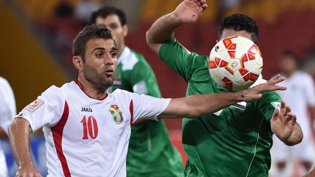 Ahmad Hayel (left) of Jordan in action during his side's loss to Iraq. 
