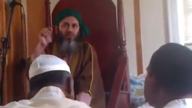 Alauddin Akhonji (in green turban) addresses worshippers at al-Furqan mosque in New York, in a video posted in September 2013.