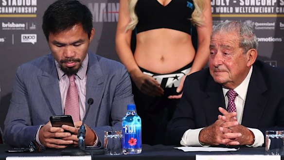 Obsession: Manny Pacquiao taps away on his phone during a press conference for the Brisbane fight. 