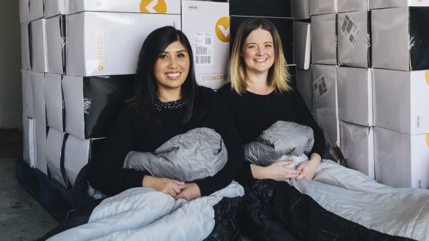 Canberrans Soudalay Thammavongsa and Emma Madsen with more than 100 sleeping bags they will donate to homeless Canberrans.