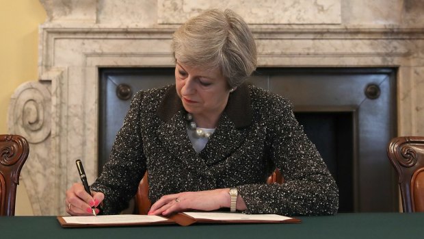 British Prime Minister Theresa May signs the official letter invoking Article 50.