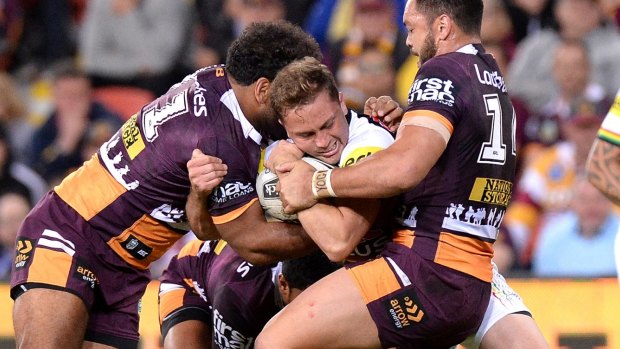 Likely fullback: Matt Moylan is wrapped up by the Broncos defence.