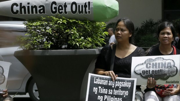 Protesters gather at the Chinese consulate in Manila to protest China's creation of artificial islands in the South China Sea. 