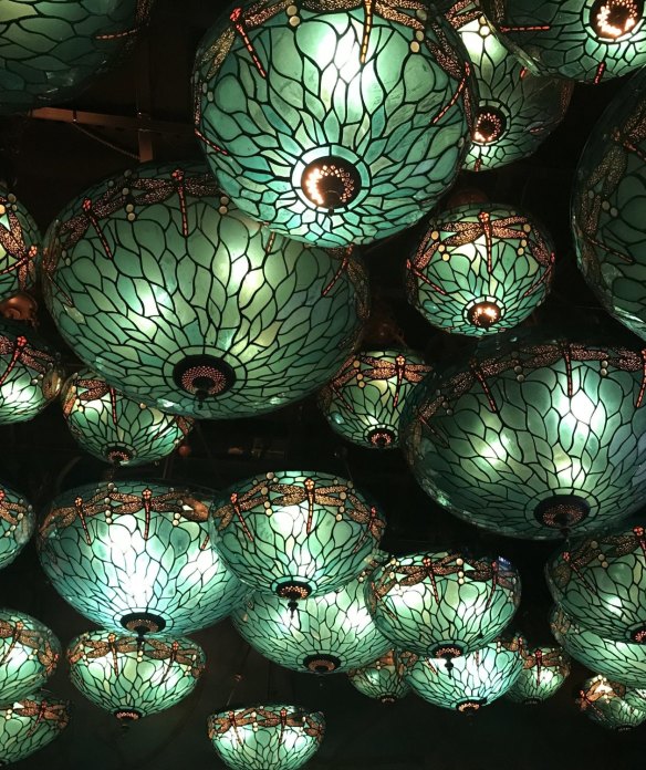 The ceiling at Hong Kong's Dragonfly is covered in turquoise Tiffany-style stained-glass lights.