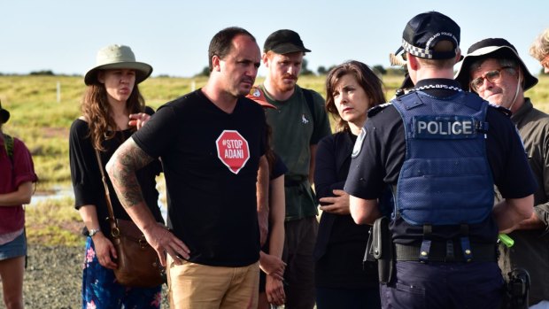 Greens MPs Jeremy Buckingham and Dawn Walker and protesters confront Queensland Police during an anti-Adani protest on Wednesday.