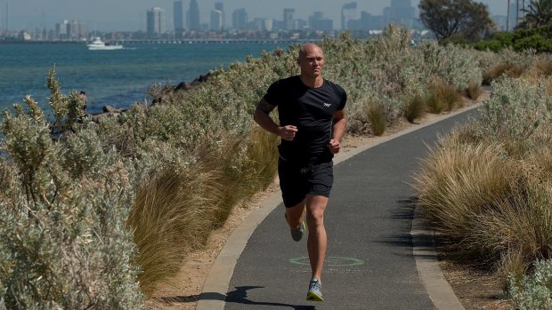 Former Olympic swimmer Michael Klim runs at Elwood Beach in Melbourne.