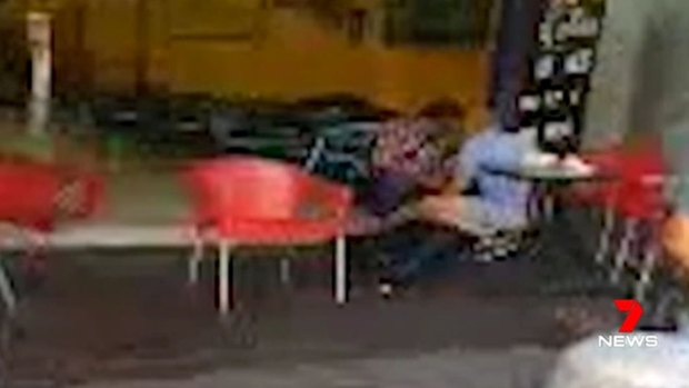 CCTV vision of two people attending to the lawyer's body at Bankstown.