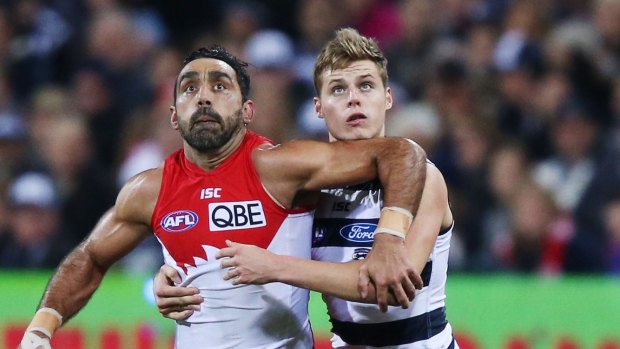 The Swans' Adam Goodes gets some attention from Cat Jake Kolodjashnij in their Saturday night clash at Simonds Stadium. 