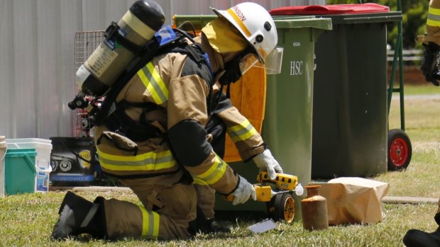 Queensland firefighters deal with the toxic canister.