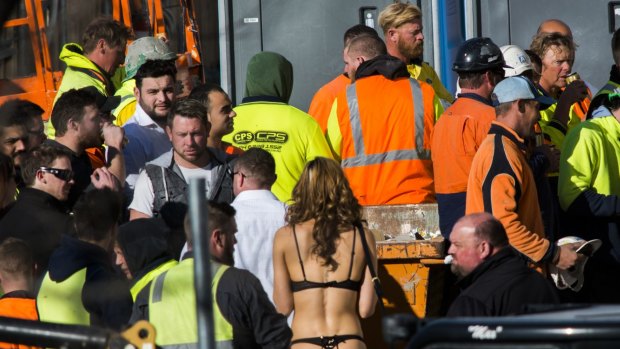 Strippers were seen handing out drinks and mingling with construction workers at the Geocon Wayfarer apartment building site in Belconnen on Friday afternoon.