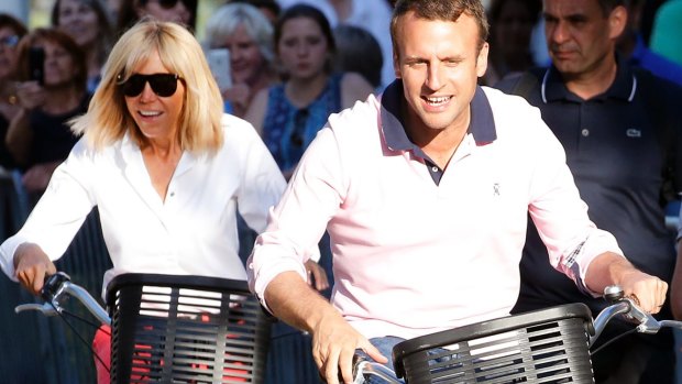 French President Emmanuel Macron and his wife Brigitte Trogneux leave their house  in Le Touquet-Paris-Plage on the eve of the second round of the French parliamentary elections.