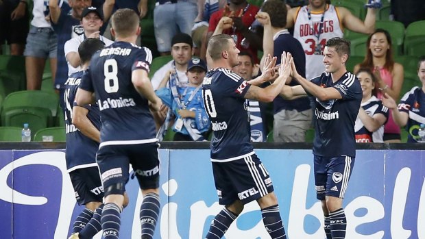 Marco Rojas (right) celebrates a goal with his Melbourne Victory teammates.