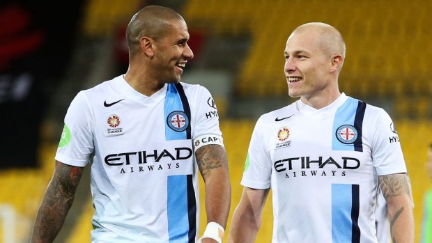 Winners are grinners: City captain Patrick Kisnorbo (left) with teammate Aaron Mooy.