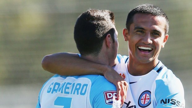 Tim Cahill shares a moment with new teammate Corey Gameiro.