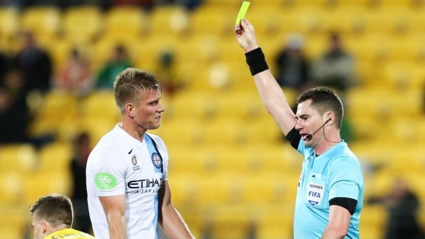 Referee Ben Williams shows Melbourne City's Erik Paartalu a yellow card during the A-League elimination final against Wellington Phoenix in Wellington on Sunday. 
