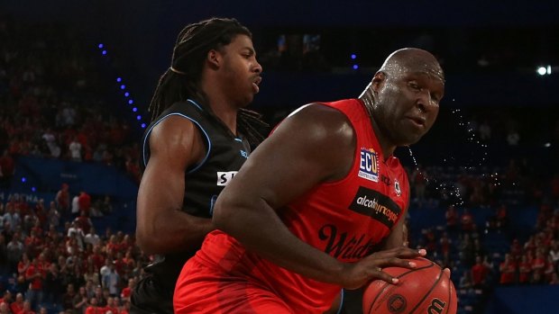 Nate Jawai of the Wildcats looks to work to the basket against Charles Jackson.