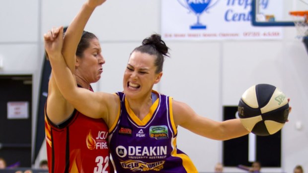 Melbourne Boomers' Tess Madgen shrugs off the attention of Townsville's Micaela Cocks. 