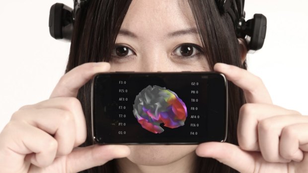 A headset that can read your mind? Le demonstrates how the Insight headset can chart brain waves on a smart phone. 