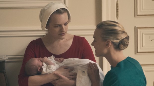 Offred (Elisabeth Moss, left) struggles to survive as a reproductive surrogate for a powerful Commander and his resentful wife, Serena Joy (Yvonne Strahovski).