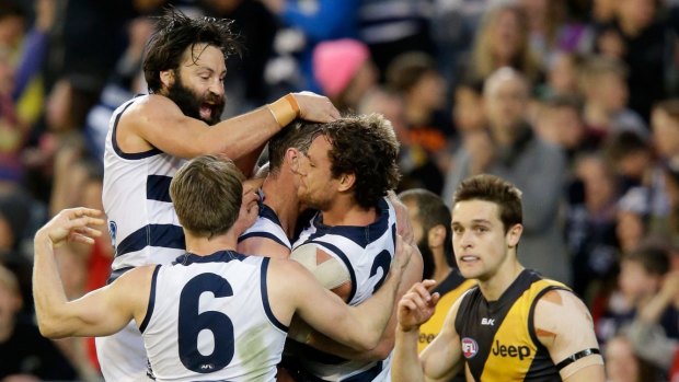 Purring along nicely: Geelong players celebrate a Tom Hawkins goal.