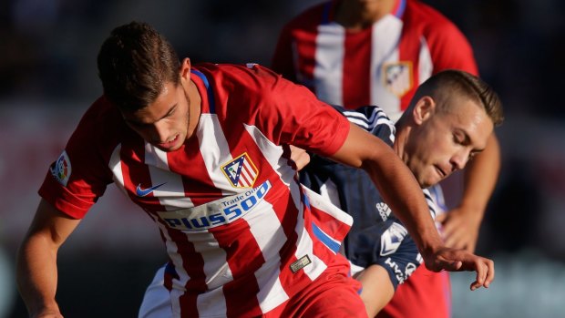 Atletico's Theo Hernandez runs the ball against Victory.