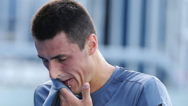 Feeling the burn: Tomic during a practice session on Sunday.