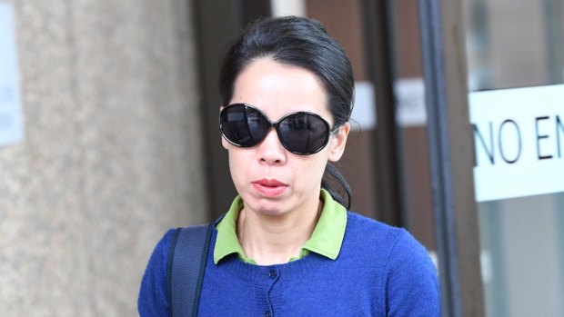 Robert Xie's wife Kathy Lin leaves the court on Thursday.