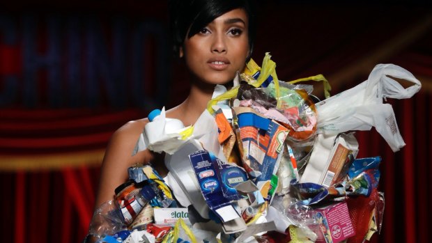 A model wears a garbage dress as part of the Moschino show.
