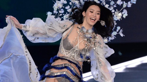 Ming Xi loses her balance on the catwalk for the Victoria's Secret Fashion Show.