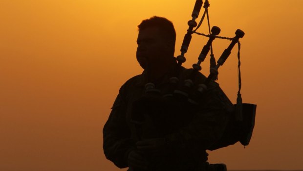 Australian Kenneth Horton, 35, from Mittagong plays at sunset in Taji, Iraq. Australian troops are training Iraqi soldiers for the fight against the so-called Islamic State.