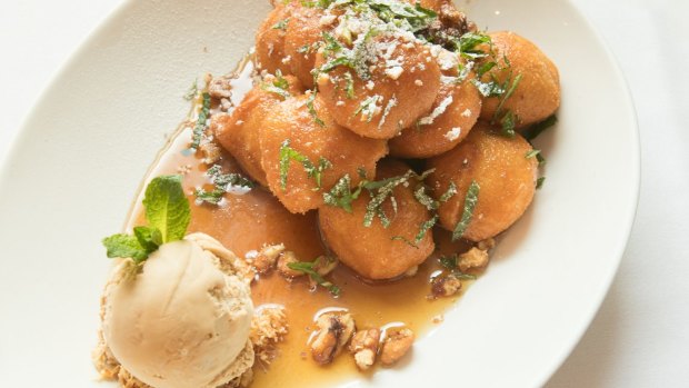 Loukoumades doused in a sugar syrup, along with a scoop of salted caramel ice cream. 