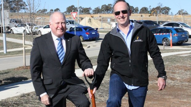 Planning Minister Mick Gentleman and Kirk Coningham from the Master Builders Association turning a sod at Moncrieff in November 2014. 