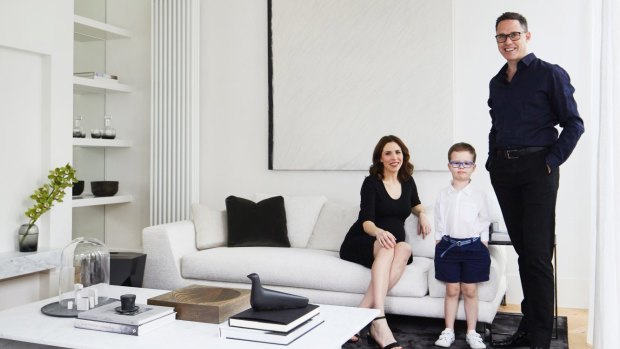 Katrina, Ollie and Paul in the formal lounge. “The monotone colour scheme creates a sense of calm and sanctuary – it’s a great place to unwind after a busy day,” says Paul. Sculptures by Bruce Rowe of Anchor Ceramics are displayed on the Carrara marble coffee table that Paul designed himself.