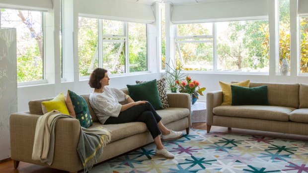 “The front room used to have a wraparound verandah which is now part of the space. We use this all the time,” says Rina. The rug is by
bernabeifreeman for Designer Rugs.