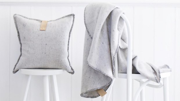 Wool-blend cushion with leather detailing, $164; Roundie wool-blend throw blanket, $199, Cabin Co Interiors, cabinco.com.au.