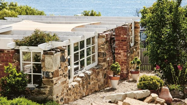 The sandstone cottage on the shore of Clarks Bay, with its outdoor entertaining area, owes its new lease of life to the efforts of Sarah and Phil Webb.