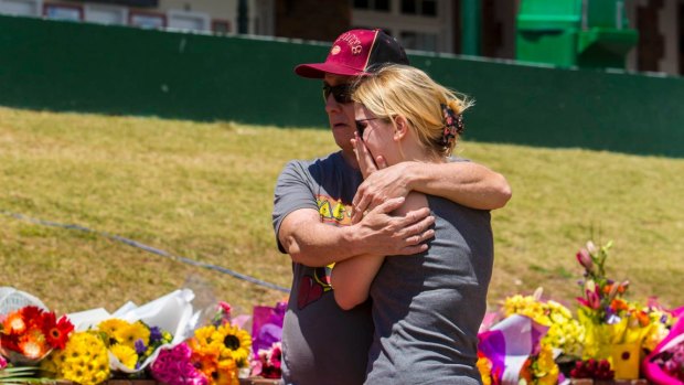 Locals grieve and pay their respects at Dreamworld where four people died after a malfunction on the Thunder River Rapids ride.
