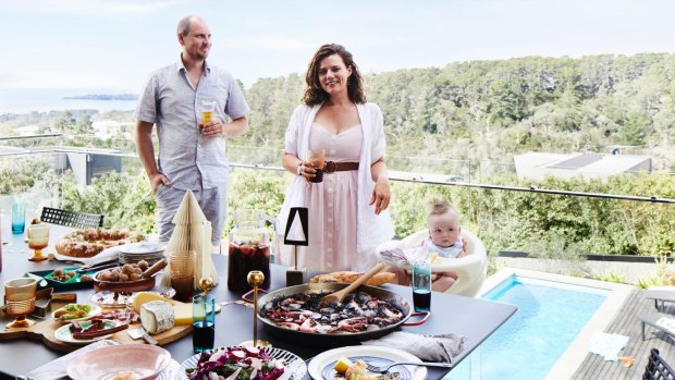 Morgan, Emma and Hector on the deck, with its views of Port Phillip Bay. “I cook and prep among my guests, which makes food the focus,” says Emma.