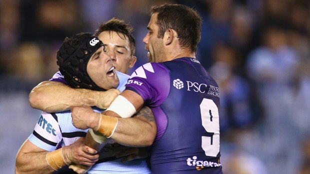 Michael Ennis scuffles with Cameron Smith and Cooper Cronk.