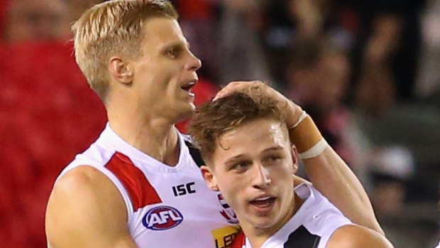 Jack Billings of the Saints is congratulated by Nick Riewoldt after kicking a goal.
