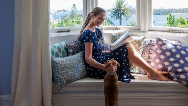 “This window seat gets sun most of the day,” says Heidi, pictured with Isabel the dachshund. “I can curl up here with a book, or even work from here.”