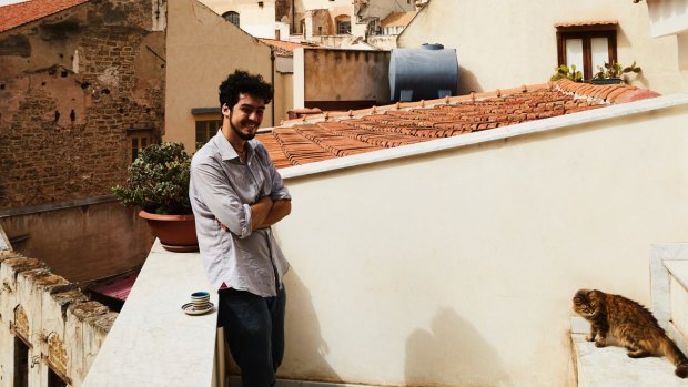 Giuseppe with his cat Nana on his apartment’s rear balcony. “From here, you can see the domes of Santa Caterina and many other beautiful churches in the town centre,” he says.