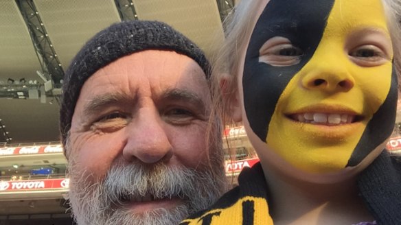 Martin Flanagan and his granddaughter Annie at the footy.